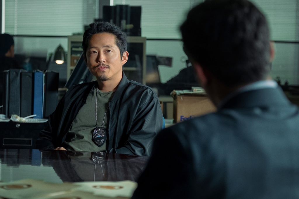 This image released by Netflix shows Steven Yeun in a scene from "The Rip." (Claire Folger/Netflix via AP)