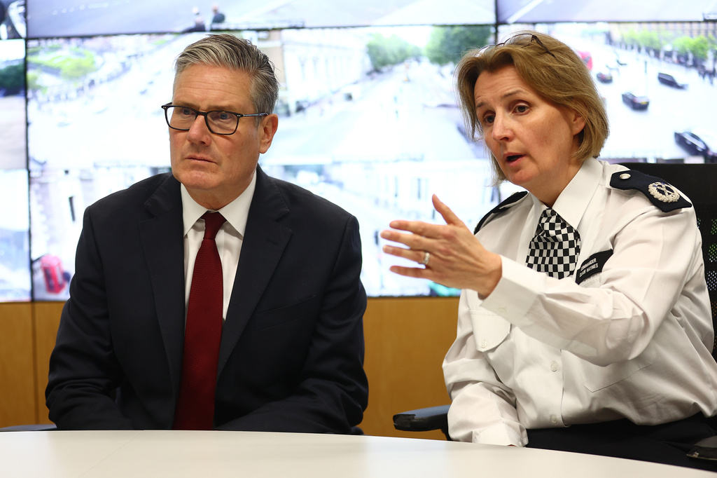 Prime Minister Keir Starmer, left, listens to Commander Clair Haynes during a meeting police officers to discuss operational planning, in London, Friday, May 15, 2026. (Peter Nicholls/Pool Photo via AP)