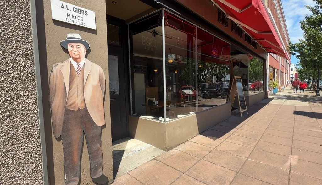 People walk down a street in downtown Longview, Wash. on May 27, 2026, one day after a deadly chemical tank failure at a paper mill. (AP Photo/Claire Rush)
