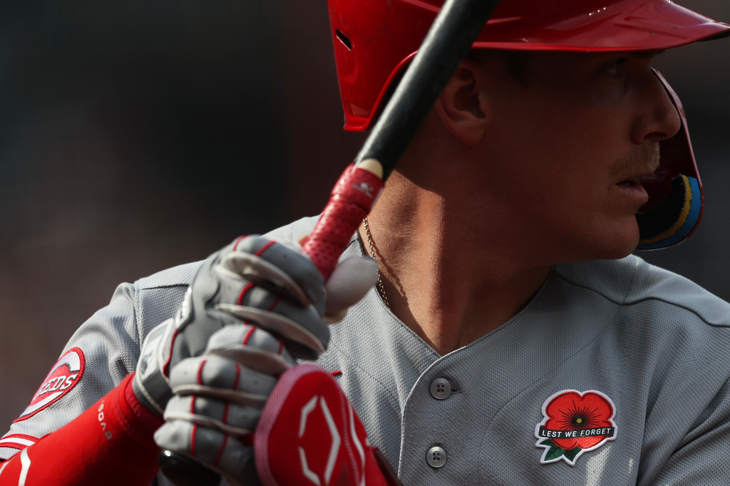 A patch for Memorial Day adorns the jersey of Cincinnati Reds' Tyler Stephenson while he waits on-deck to bat during the second inning of a baseball game against the New York Mets, Monday, May 25, 2026, in New York. (AP Photo/Heather Khalifa)