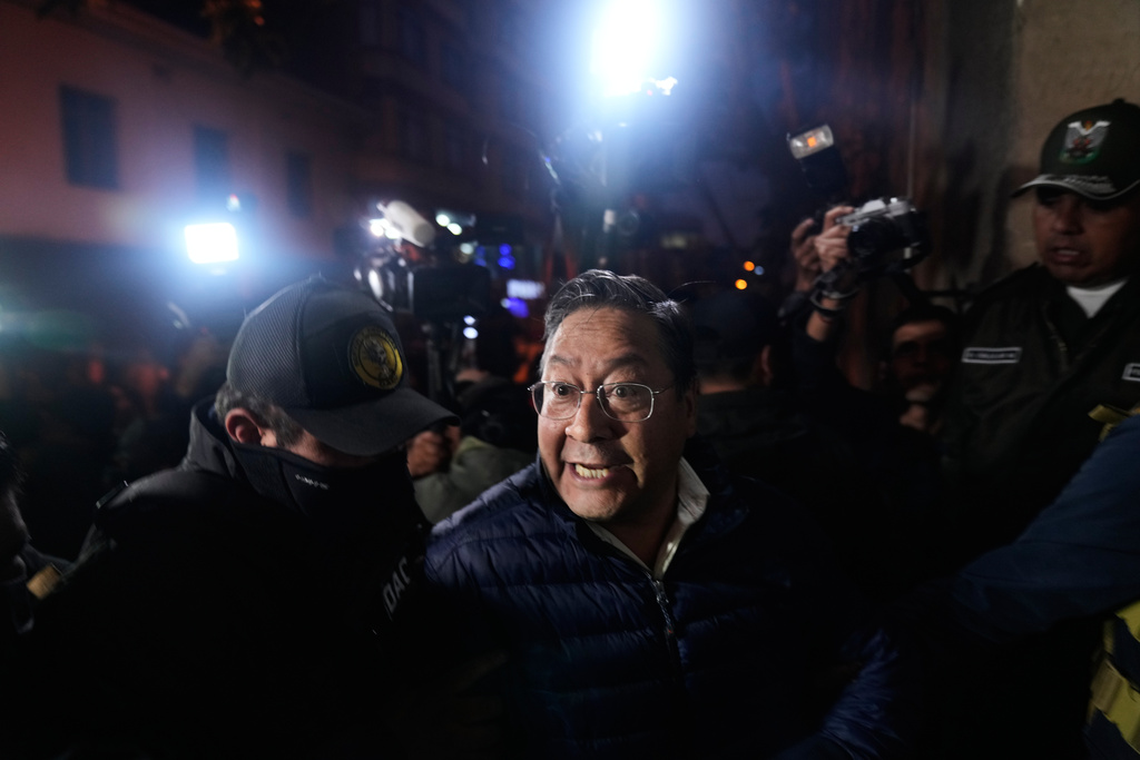 Police officers escort former President Luis Arce to San Pedro Prison after his arrest as part of a corruption investigation in La Paz, Bolivia, Friday, Dec. 12, 2025. (AP Photo/Juan Karita)