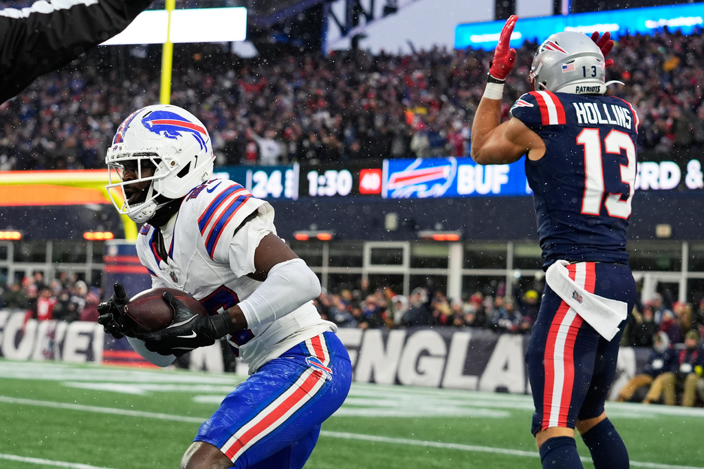 Buffalo Bills cornerback Tre'Davious White, left, reacts after intercepting a pass intended for New England Patriots wide receiver Mack Hollins (13) during the second half of an NFL football game in Foxborough, Mass., Sunday, Dec. 14, 2025. (AP Photo/Robert F. Bukaty)