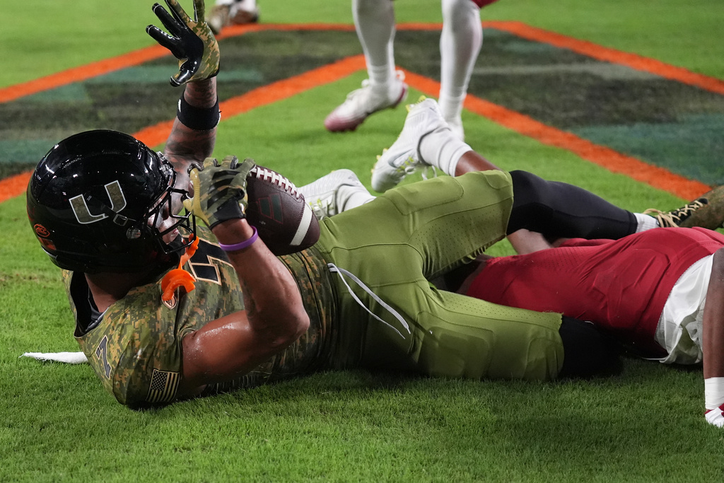 Miami wide receiver CJ Daniels attempts a catch in the endzone which was ruled an incomplete pass during the first half of an NCAA college football game against Stanford, Saturday, Oct. 25, 2025, in Miami Gardens, Fla. (AP Photo/Lynne Sladky)