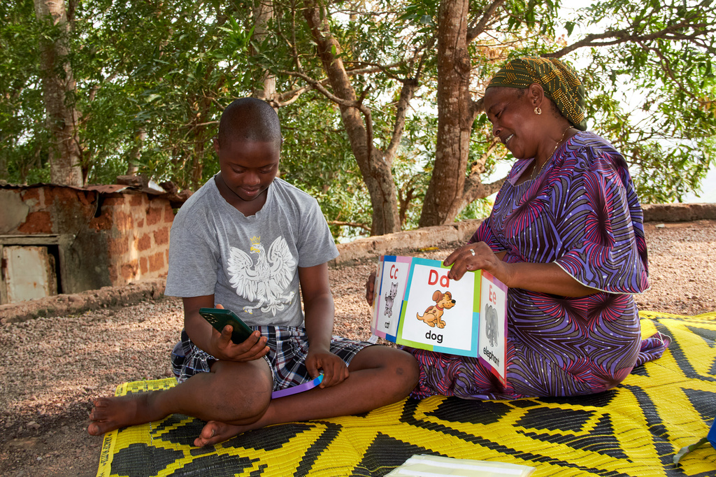 Kadiatou Diallo spends time with her autistic child, Kazaliou Balde, at their home in Fria, Guinea, Saturday, May 16, 2026. (AP Photo/Fode Toure)