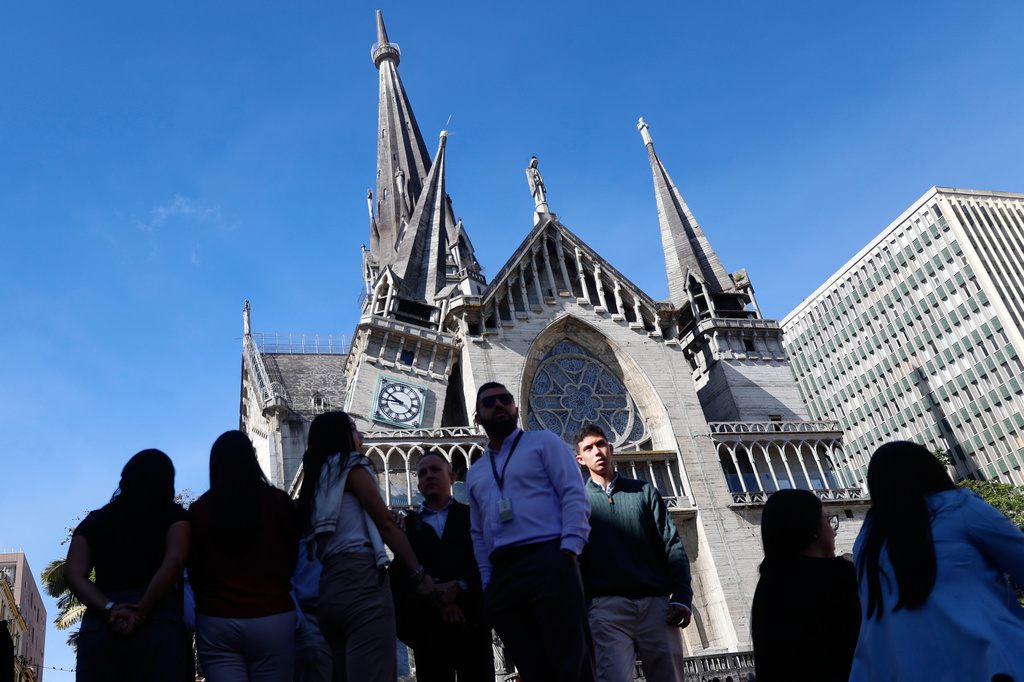 Residents stand outside the Cathedral of Manizales after it was damaged by an earthquake in Manizales, Colombia, Monday, Aug. 10, 2026.(AP Photo/John Jairo Bonilla)