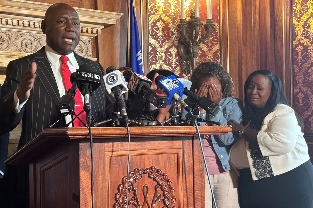 Attorney Ben Crump speaks at a news conference about Corey Ruiz, who was killed by Madison police, while his sister, Veronica Ruiz, breaks down in tears and is comforted by Wisconsin state Rep. Shelia Stubbs, D-Madison, right, Friday, July 24, 2026, in Madison, Wis. (AP Photo/Scott Bauer)