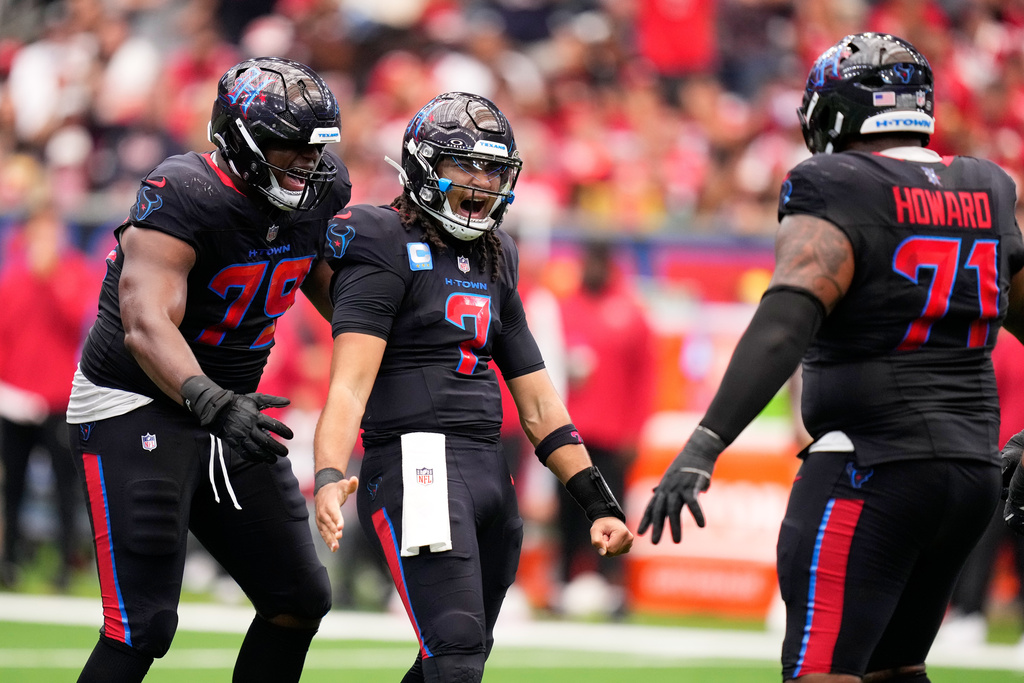 Houston Texans quarterback C.J. Stroud (7) is congratulated by teammates Aireontae Ersery (79) and Tytus Howard (71) after throwing a touchdown pass during the second half of an NFL football game against the San Francisco 49ers Sunday, Oct. 26, 2025, in Houston. (AP Photo/Eric Christian Smith)