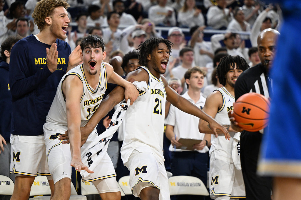 Michigan players, from left, Malick Kordel, Aday Mara, Morez Johnson Jr. and Elliot Cadeau celebrate on the bench late in the second half of a win over UCLA in an NCAA college basketball game in Ann Arbor, Mich., Saturday, Feb. 14, 2026. (AP Photo/Lon Horwedel)