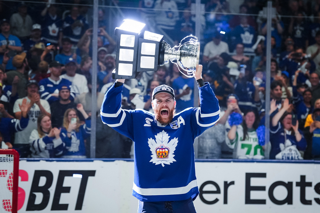 Toronto Marlies defenseman Dakota Mermis (36) hoists the Calder Cup after the Toronto Marlies won Game 5 of the AHL Calder Cup Final over the Chicago Wolves in Toronto on Friday, June 19, 2026. (Arlyn McAdorey/The Canadian Press via AP)
