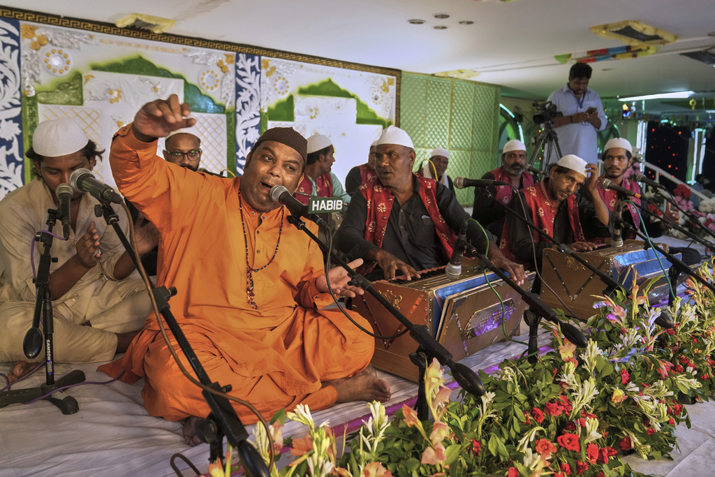 A group of singers perform 'Qawwali', a form of Sufi devotional music, during the celebrations of the three-day annual festival or 'Urs' of mystic and scholar Hazrat Ali Hajveri, popularly known as Data Ganj Bakhsh at his shrine, in Lahore, Pakistan, Friday, Aug. 15, 2025. (AP Photo/K.M. Chaudary)