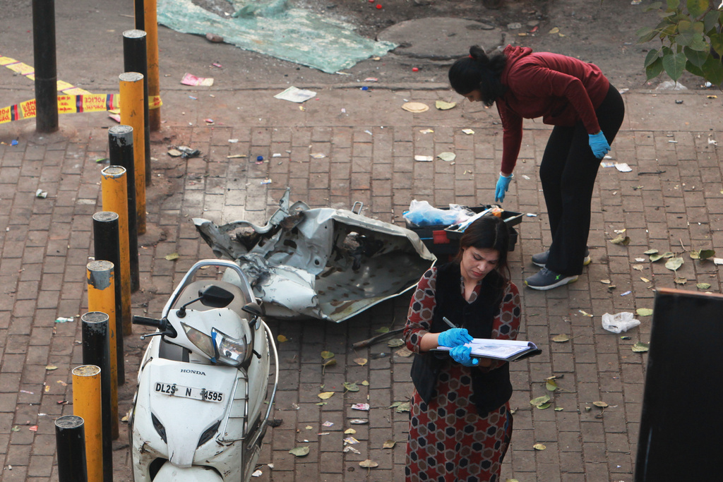 Investigators examine the site of Monday's car explosion near the historic Red Fort, in New Delhi, India, Tuesday, Nov. 11, 2025. (AP Photo)