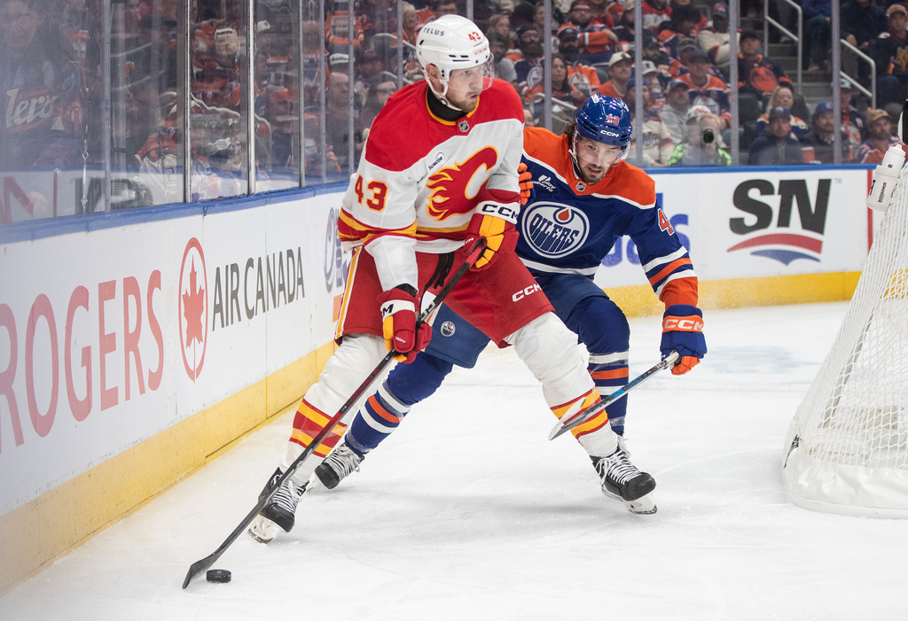 Calgary Flames' Adam Klapka (43) and Edmonton Oilers' Matt Savoie (48) battle for the puck during first period NHL action, in Edmonton on Wednesday, Oct. 8, 2025. (Jason Franson/The Canadian Press via AP)