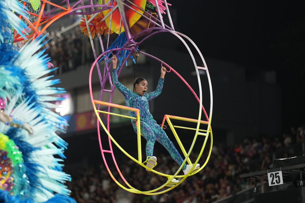 A dancer from the Mocidade Unida da Mooca samba school performs on a float during a carnival parade in Sao Paulo, Friday, Feb. 13, 2026. (AP Photo/Andre Penner)