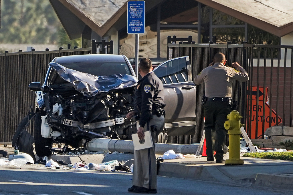 FILE - Two investigators stand next to a mangled SUV that struck Los Angeles County sheriff's recruits in Whittier, Calif., Wednesday, Nov. 16, 2022. (AP Photo/Jae C. Hong, File)