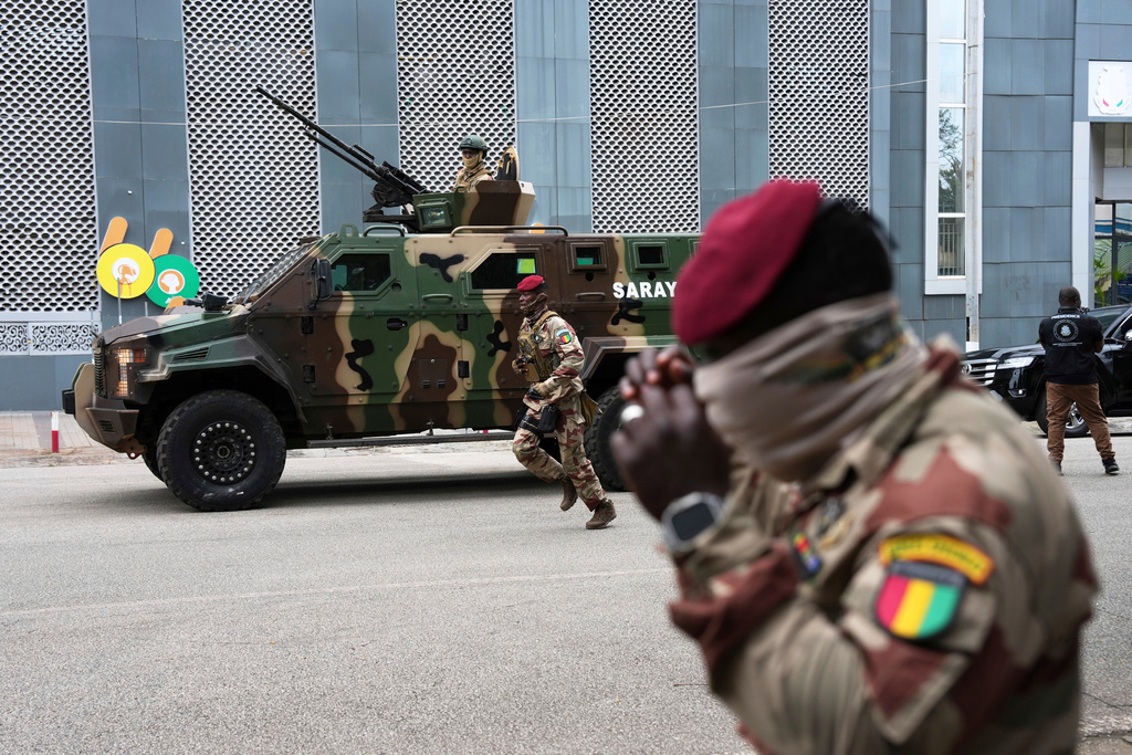 FILE - Guinean soldiers secure the area outside a polling station before Gen. Mamadi Doumbouya arrives to cast his vote in the constitutional referendum, in Conakry, Guinea, Sunday, Sept. 21, 2025. (AP Photo/Misper Apawu, File)