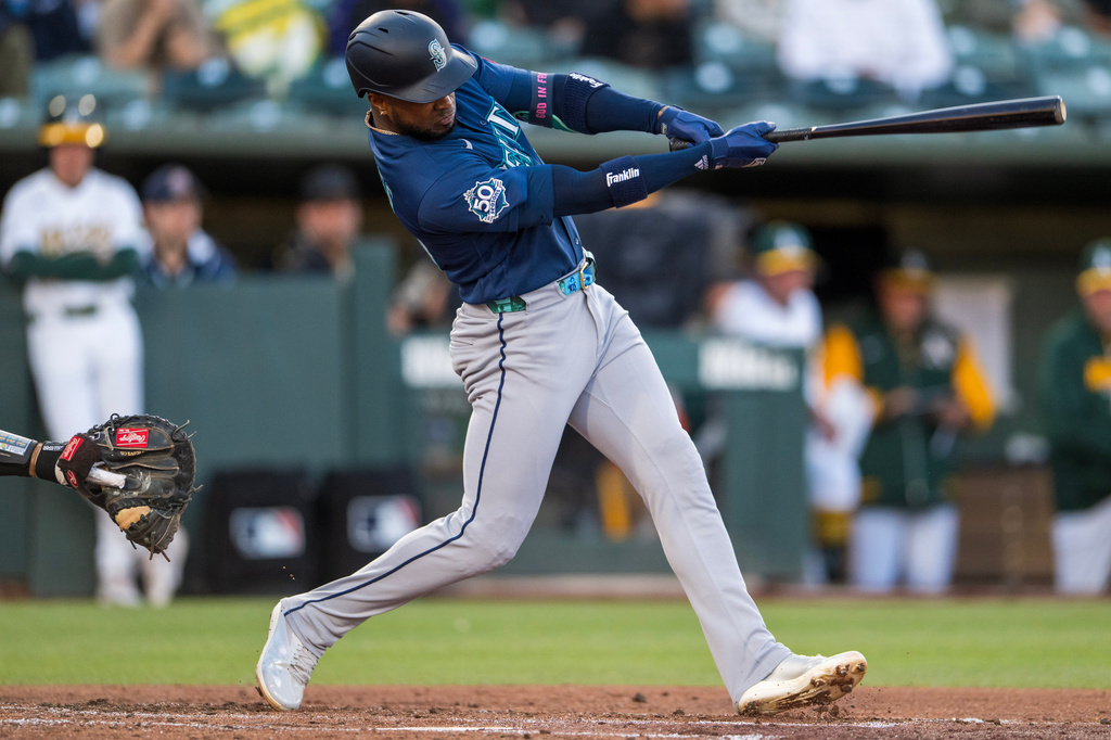 Seattle Mariners' Victor Robles hits during the fourth inning of a baseball game against the Athletics in West Sacramento, Calif., Tuesday, May 26, 2026. (AP Photo/Nic Coury)