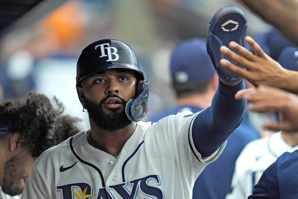 Tampa Bay Rays' Junior Caminero celebrates with teammates after scoring on an RBI triple by Ryan Vilade off Baltimore Orioles pitcher Trevor Rogers during the fourth inning of a baseball game Monday, May 18, 2026, in St. Petersburg, Fla. (AP Photo/Chris O'Meara)
