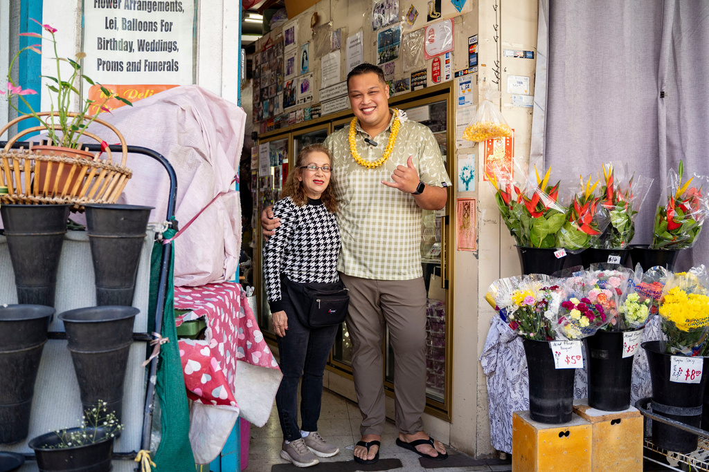 Mei Mei Say, owner of M.P. Lei Shop, left, poses for a photo with State Rep. Darius Kila, D-Nanakuli, in Chinatown, Thursday, Feb. 26, 2026, in Honolulu. (AP Photo/Mengshin Lin)