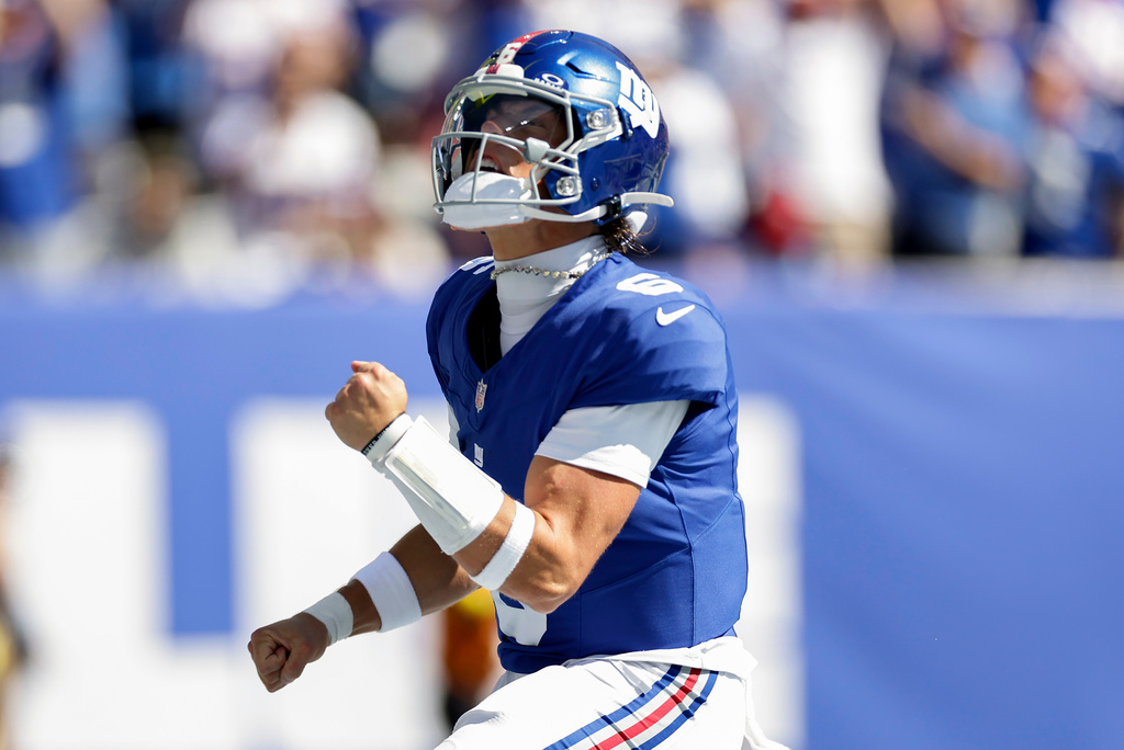 New York Giants quarterback Jaxson Dart (6) reacts after scoring a touchdown against the Los Angeles Chargers during the first quarter of an NFL football game, Sunday, Sept. 28, 2025, in East Rutherford, N.J. (AP Photo/Adam Hunger)