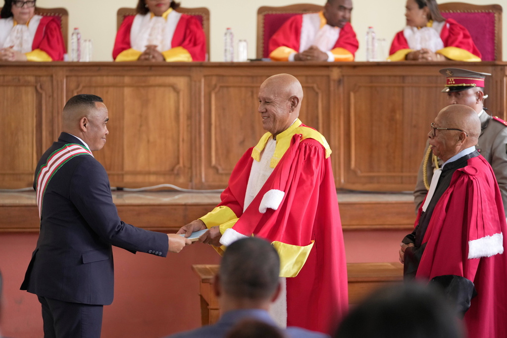 Madagascar High Constitutional Court judges congratulates Col. Michael Randrianirina, sworn in as president, at the main chamber of the nation's High Constitutional Court, in Antananarivo, Madagascar, Friday, Oct. 17, 2025. (AP Photo/Brian Inganga)