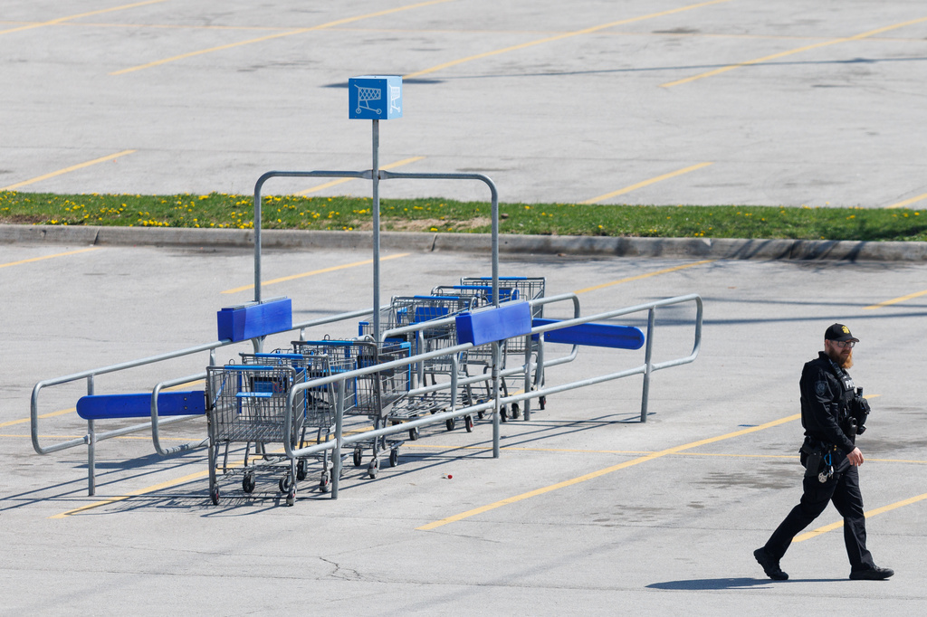 Omaha police work outside a Walmart store at South 72nd and Pine Streets in Omaha, Neb., on Tuesday, April 14, 2026, after police fatally shot a woman who was accused of cutting a young child's face with a knife. (Nikos Frazier/Omaha World-Herald via AP)