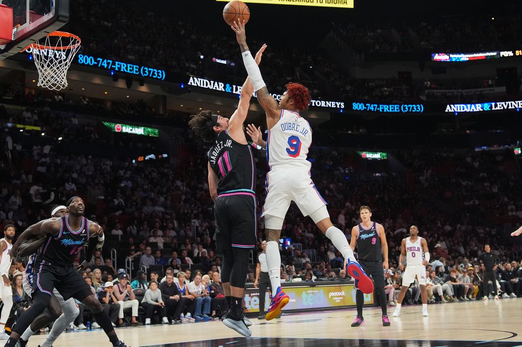 Philadelphia 76ers guard Kelly Oubre Jr. (9) shoots as Miami Heat forward Jaime Jaquez Jr. (11) defends during the first half of an NBA basketball game, Monday, March 30, 2026, in Miami. (AP Photo/Lynne Sladky)