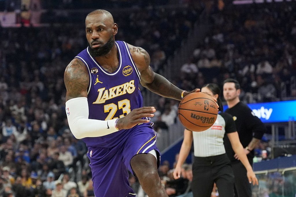 Los Angeles Lakers forward LeBron James (23) drives to the basket against the Golden State Warriors during the first half of an NBA basketball game in San Francisco, Thursday, April 9, 2026. (AP Photo/Jeff Chiu)