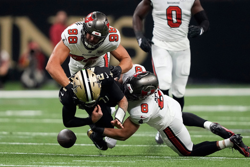 New Orleans Saints quarterback Spencer Rattler (2) fumbles the ball after getting hit by Tampa Bay Buccaneers linebacker SirVocea Dennis (8) and linebacker Anthony Nelson (98) during the first half of an NFL football game Sunday, Oct. 26, 2025, in New Orleans. (AP Photo/Gerald Herbert) New Orleans Saints quarterback Spencer Rattler (2) fumbles the ball after getting hit by Tampa Bay Buccaneers linebacker SirVocea Dennis (8) and linebacker Anthony Nelson (98) during the first half of an NFL football game Sunday, Oct. 26, 2025, in New Orleans. (AP Photo/Gerald Herbert)