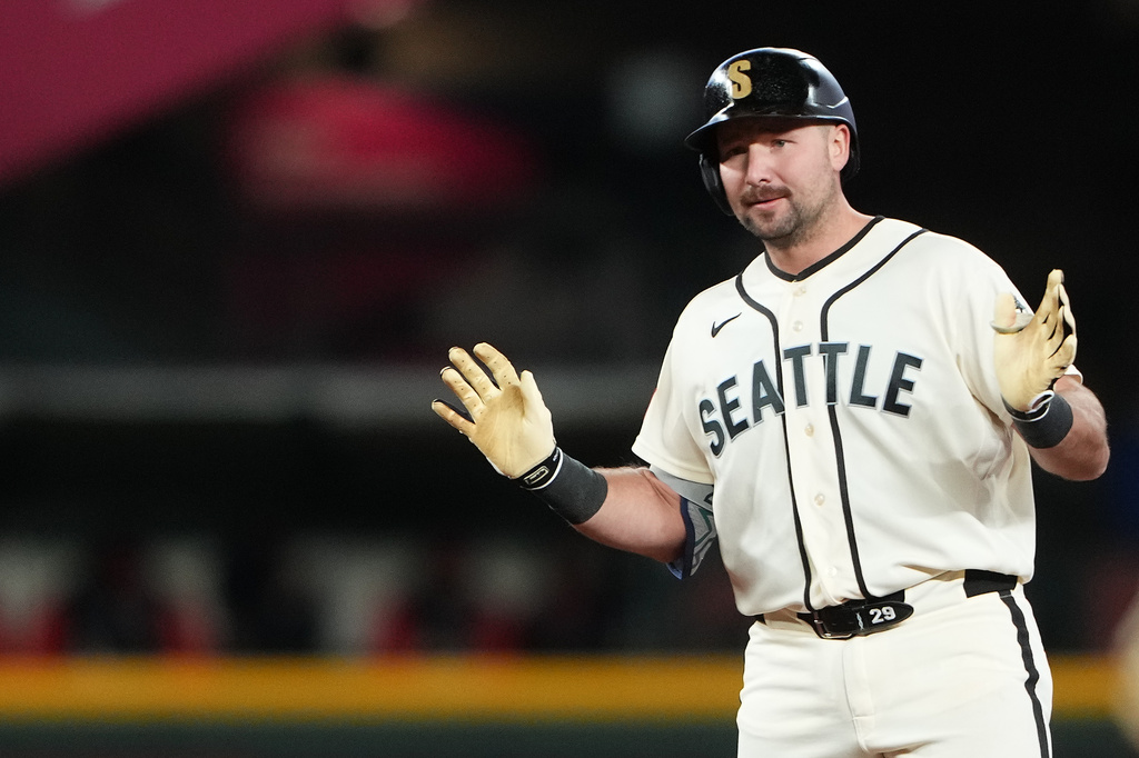 Seattle Mariners' Cal Raleigh reacts after hitting an RBI ground rule double against the Cleveland Guardians during the sixth inning of a baseball game, Sunday, March 29, 2026, in Seattle. (AP Photo/Lindsey Wasson)
