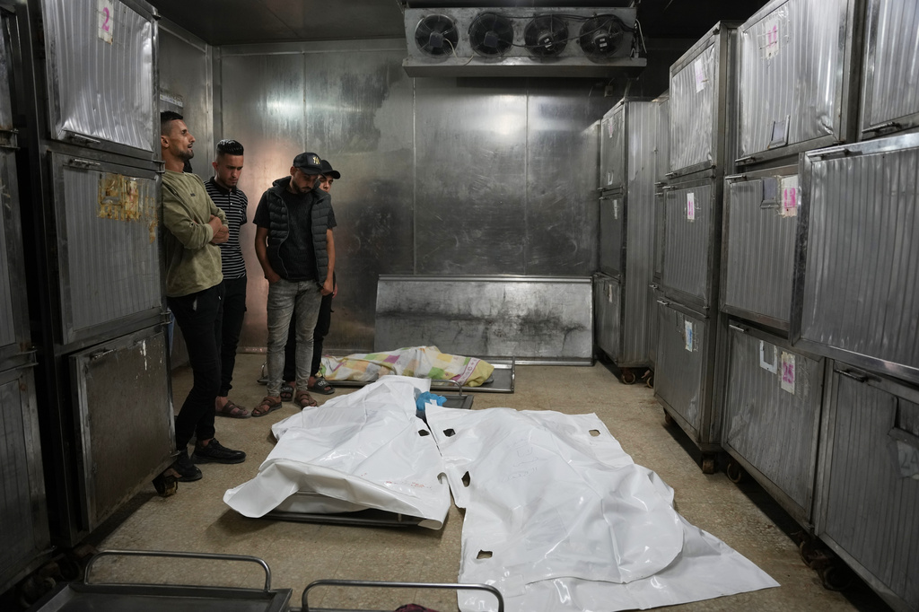 Mourners take the last look at the bodies of two Palestinian girls Zeina Safadi, and her sister Lana, who were killed during an overnight Israeli airstrike when it damaged their home, during their funeral in Gaza city, Saturday, June 20, 2026. (AP Photo/Abdel Kareem Hana)