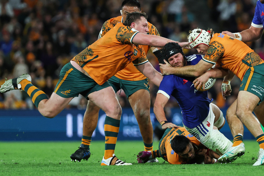 France's Lenni Nouchi is tackled by Australia's Angus Bell, left, and Fraser McReight, right, during the Nations Championship rugby international between France and Australia in Brisbane, Australia, Saturday, July 11, 2026. (AP Photo/Tertius Pickard)