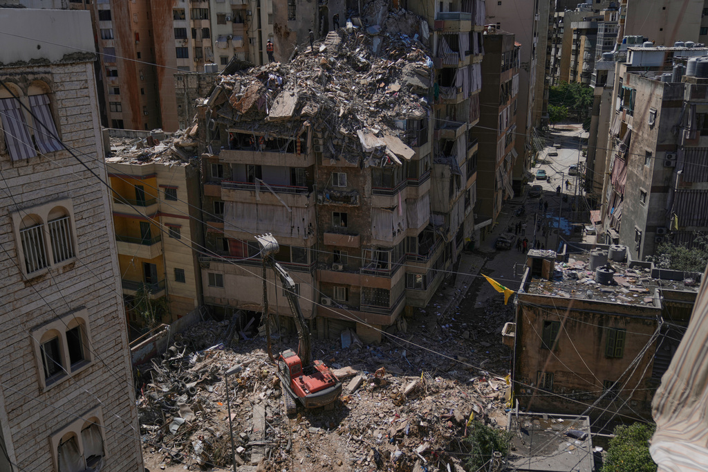 Rescue workers search through the rubble of a building destroyed in an Israeli airstrike the previous day in Dahiyeh, Beirut's southern suburbs, Lebanon, Thursday, May 7, 2026. (AP Photo/Bilal Hussein)