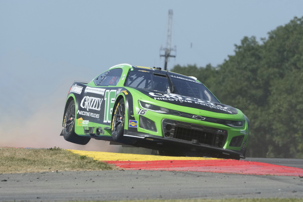 AJ Allmendinger (16) gets some air leaving the Bus Stop during a NASCAR Cup Series auto race in Watkins Glen, N.Y., Sunday, Aug. 10, 2025. (AP Photo/Seth Wenig)