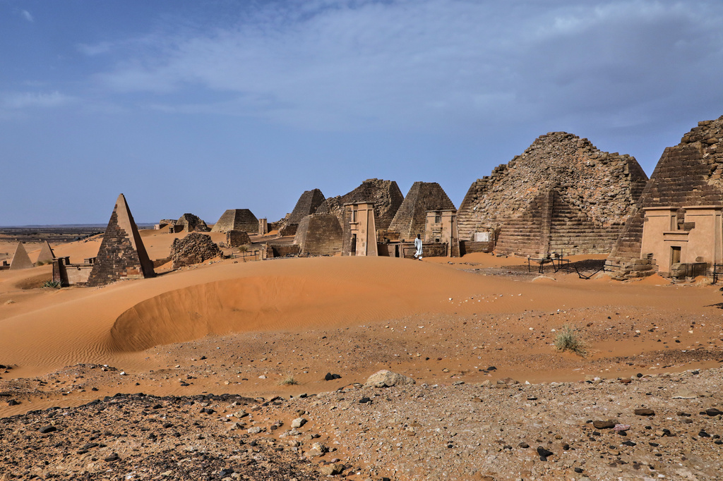 A visitor walks among the Meroe pyramids at the Meroe archaeological site in Bejrawiya, Sudan, Saturday, Aug. 1, 2026. (AP Photo/Mohnd Blal)