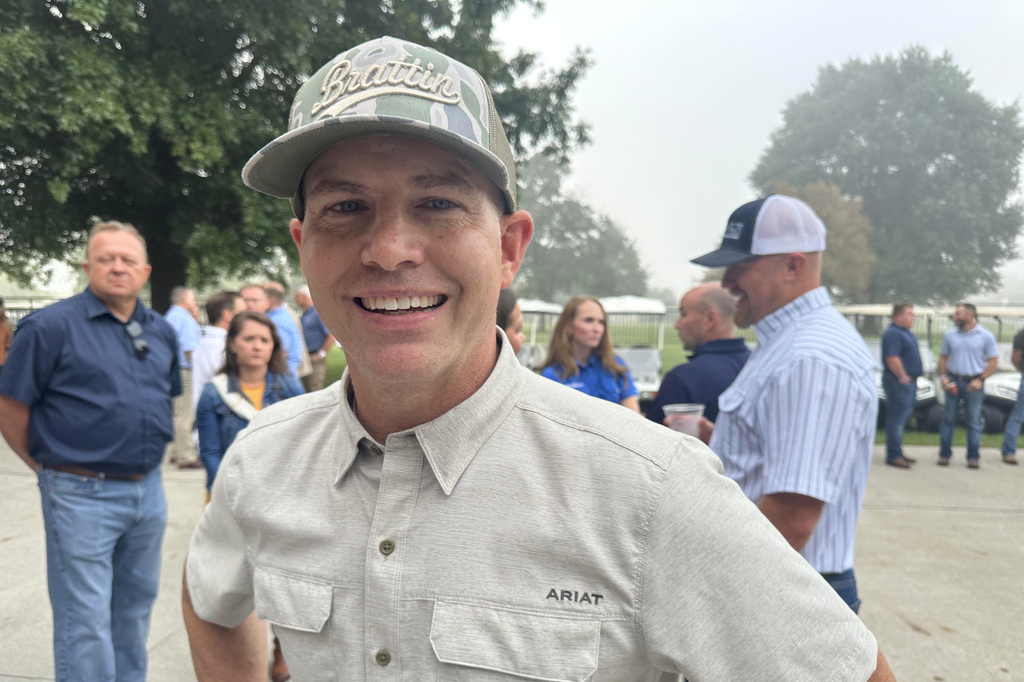 In this photo taken with a smartphone, Republican state Sen. Rick Brattin campaigns at the Missouri State Fairgrounds on Thursday, Aug. 20, 2026, Sedalia, Mo. (AP Photo/David A. Lieb)