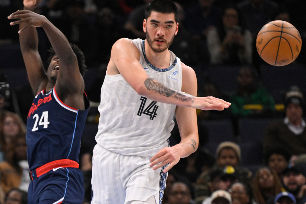 FILE - Memphis Grizzlies center Zach Edey (14) passes away from Los Angeles Clippers forward Kobe Brown (24) during an NBA basketball game Friday, Dec. 5, 2025, in Memphis, Tenn. (AP Photo/John Amis, file)
