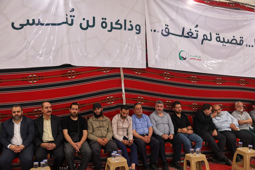 Residents gather to mourn former chess champion Rania al-Abbasi and her family, who disappeared 13 years ago, after relatives announced Monday they had evidence the family was killed by pro-government gunmen in 2013, in Damascus, Syria, Tuesday, June 2, 2026. (AP Photo/Ghaith Alsayed)