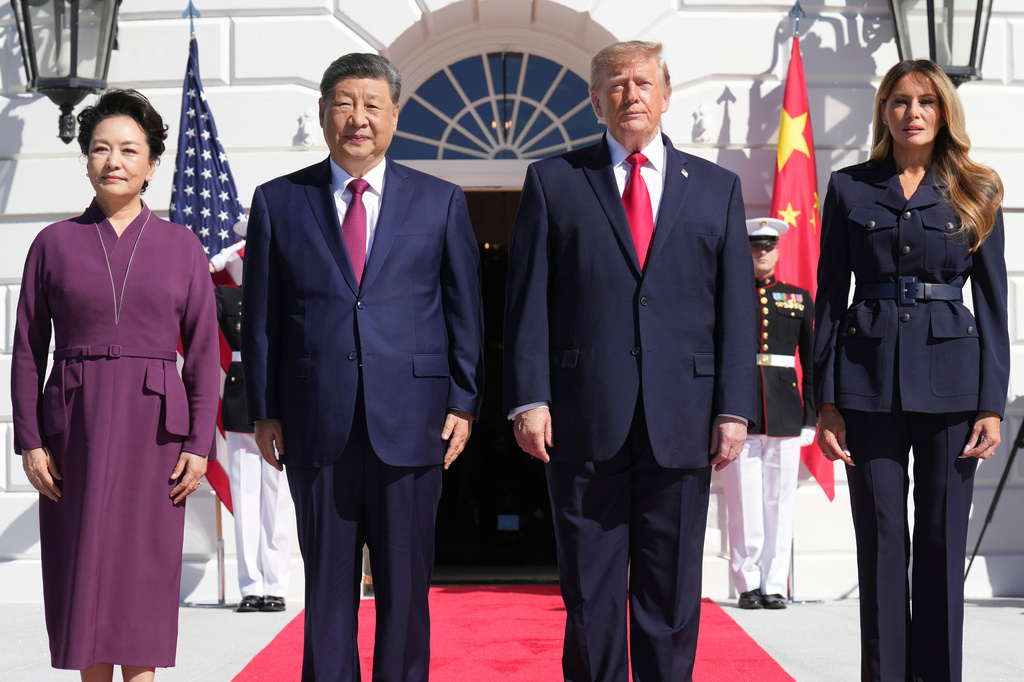 President Donald Trump, center right, and first lady Melania Trump, right, pose as they greet China's President Xi Jinping, center left, and his wife Peng Liyuan, as they arrive at the South Portico of the White House for tea, Friday, Sept. 25, 2026, in Washington. (AP Photo/Jacquelyn Martin)
