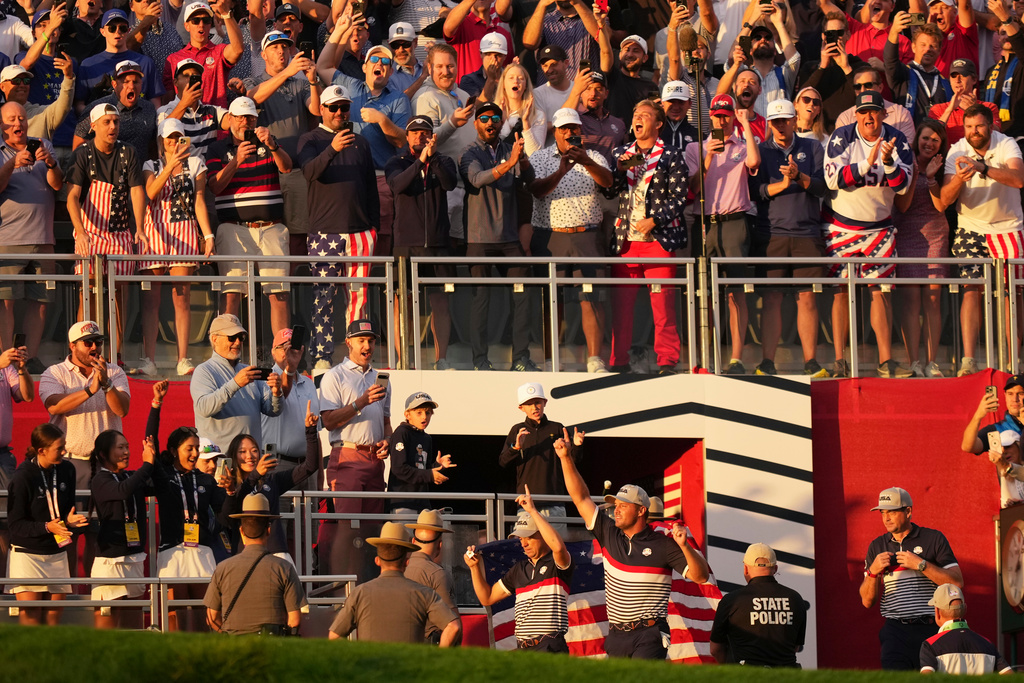 United States' Bryson DeChambeau and Justin Thomas wave to the crowd on the first hole at Bethpage Black golf course during the Ryder Cup golf tournament, Friday, Sept. 26, 2025, in Farmingdale, N.Y. (AP Photo/Matt Slocum)