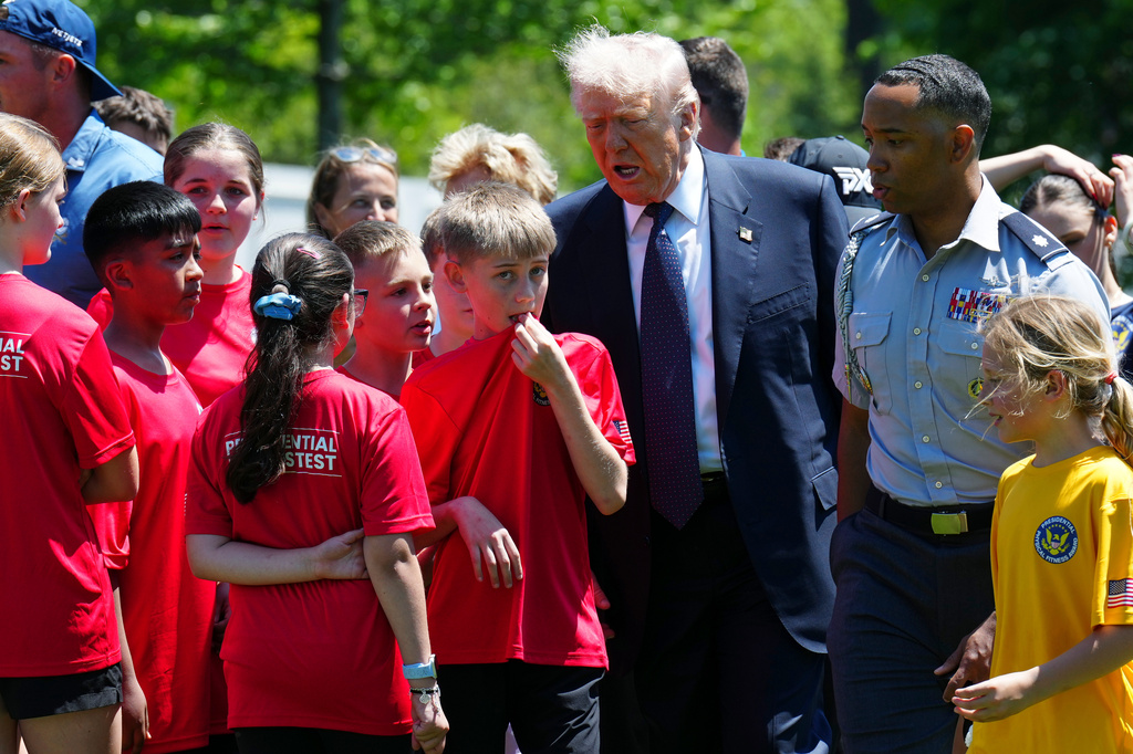 President Donald Trump walks with kids during exercise drills on the south lawn of the White House, Tuesday, May 5, 2026, in Washington. (AP Photo/Jacquelyn Martin)