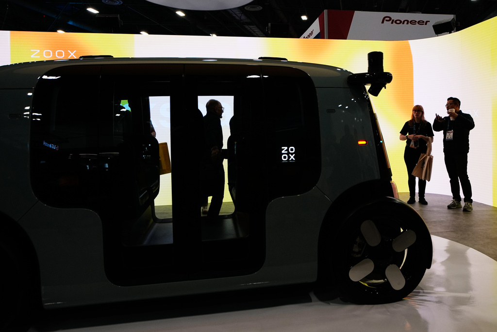 People look at a Zoox vehicle during the CES tech show Tuesday, Jan. 6, 2026, in Las Vegas. (AP Photo/John Locher)