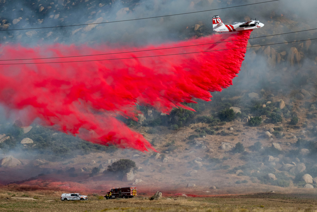 Cal Fire tanker 70 makes a fire retardant dump battling the Springs Fire in the Moreno Valley area Friday, April 3, 2026, in Riverside County, Calif. (Terry Pierson/The Orange County Register via AP)