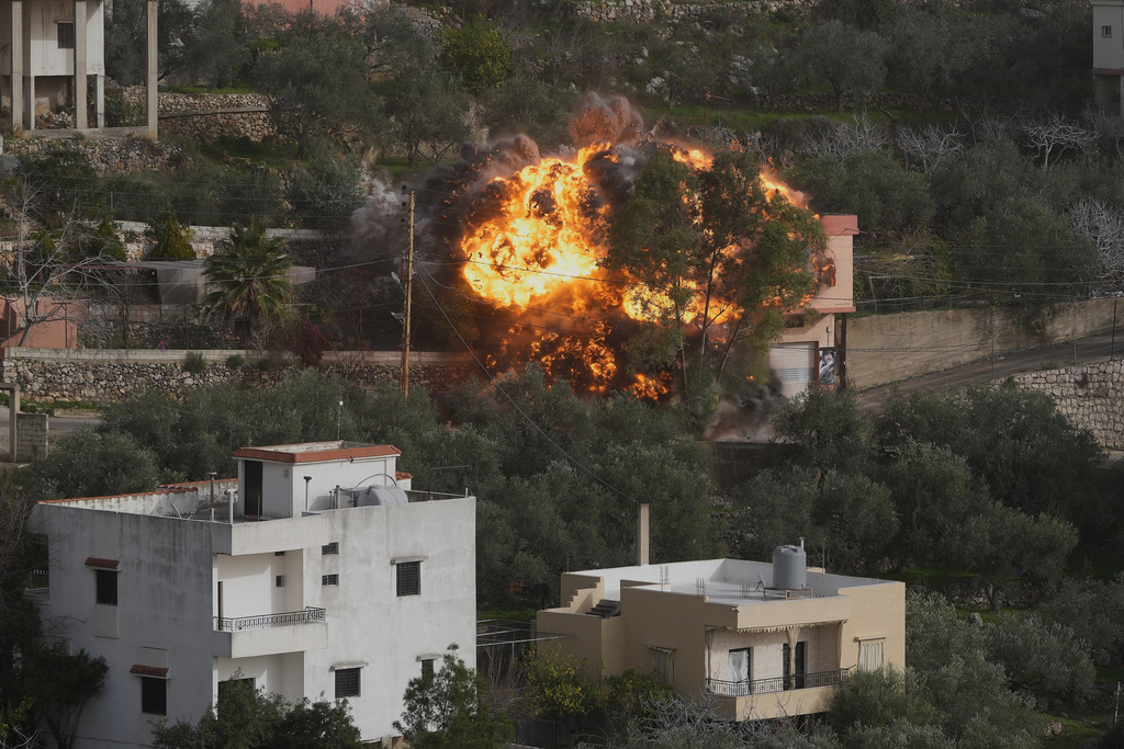 FILE - Flames rise from a building that was hit by an Israeli airstrike in Ain Qana village, south Lebanon, on Feb. 2, 2026. (AP Photo/Mohammed Zaatari, File)