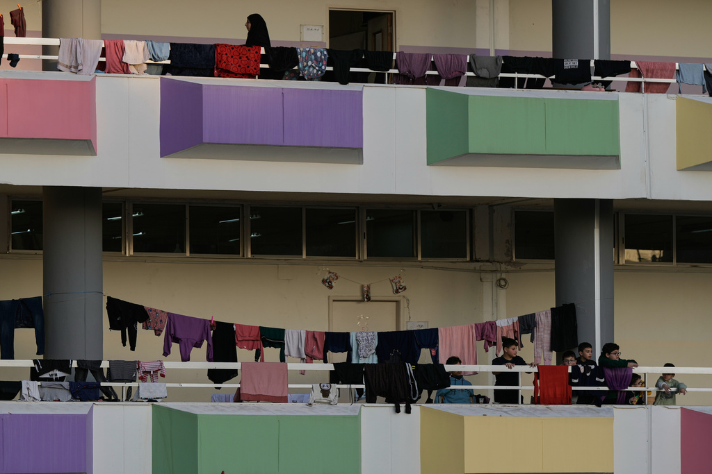 Displaced people fleeing Israeli airstrikes in southern Lebanon and Dahiyeh, Beirut's southern suburbs, settle at a school turned into a shelter in Beirut, Lebanon, Thursday, March 5, 2026. (AP Photo/Bilal Hussein)