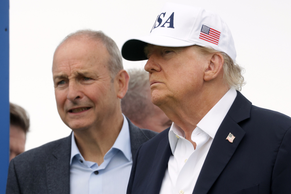 U.S. President Donald Trump and Ireland's Prime Minister Micheal Martin arrive at the first tee during the Irish Open at the Trump International Golf Links course in Doonbeg, Ireland, Sunday, Sept. 13, 2026.(AP Photo/Peter Morrison)