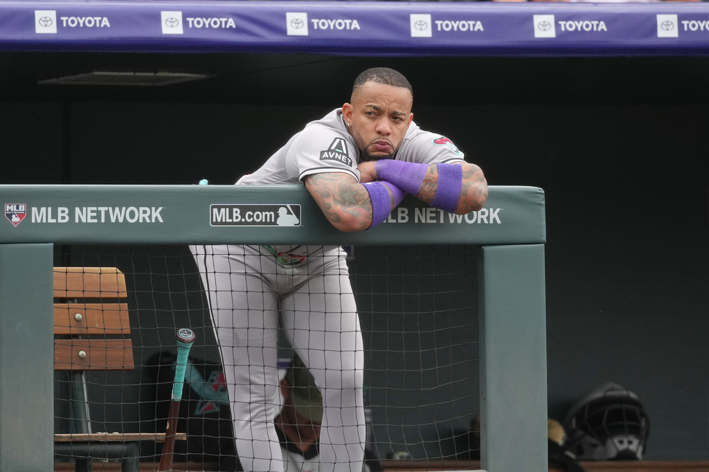 Arizona Diamondbacks designated hitter Ketel Marte leans over the dugout rail as he looks on in the fifth inning of a baseball game against the Colorado Rockies, Saturday, May 16, 2026, in Denver. (AP Photo/David Zalubowski)