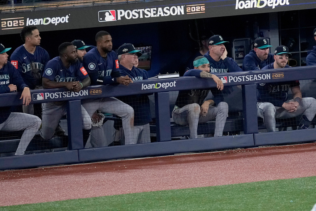 The Seattle Mariners watch from their dugout during the ninth inning in Game 7 of baseball's American League Championship Series against the Toronto Blue Jays, Monday, Oct. 20, 2025, in Toronto. (AP Photo/David J. Phillip)