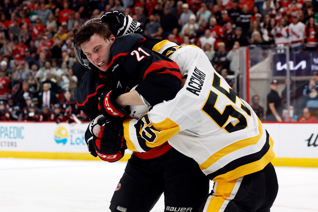 Carolina Hurricanes' Alexander Nikishin (21) exchanges blows wih Pittsburgh Penguins' Ryan Shea (5) during the second period of an NHL hockey game in Raleigh, N.C., Tuesday, March 10, 2026. (AP Photo/Karl DeBlaker)