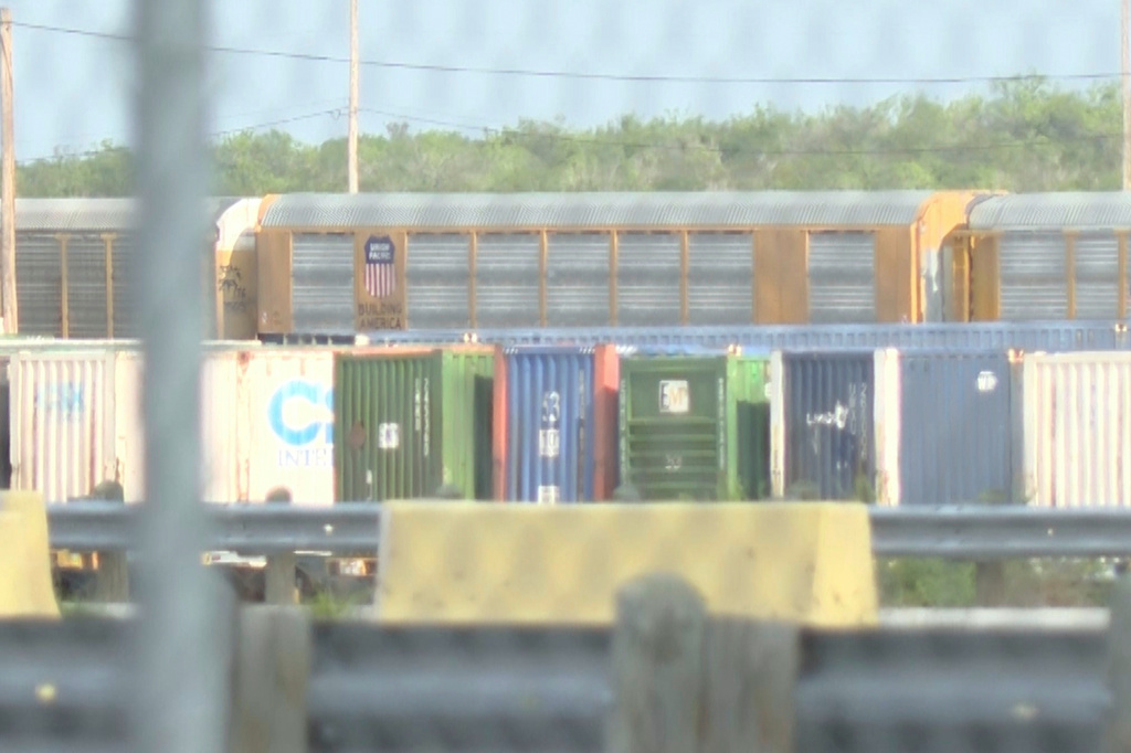 In this image taken from video footage provided by KGNS, Union Pacific train cars are stationed at a rail yard in Laredo, Texas, Sunday, May 10, 2026. (KGNS via AP)