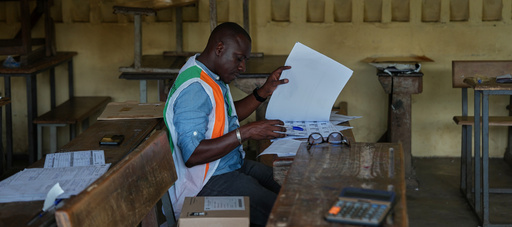An election official looks through a voter register at a polling station in Yopougon during the presidential elections in Abidjan, Ivory Coast, Saturday, Oct. 25, 2025. (AP Photo/Misper Apawu) An election official looks through a voter register at a polling station in Yopougon during the presidential elections in Abidjan, Ivory Coast, Saturday, Oct. 25, 2025. (AP Photo/Misper Apawu)